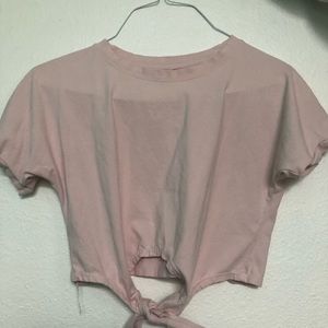 Baby pink top with a tie on the bottom